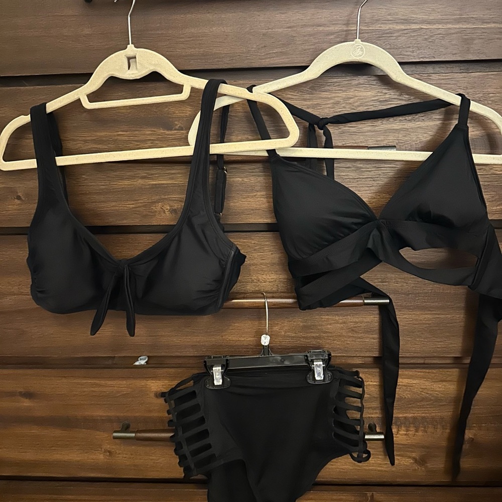 Black bikini with cut out sides bottoms and 2 tops.